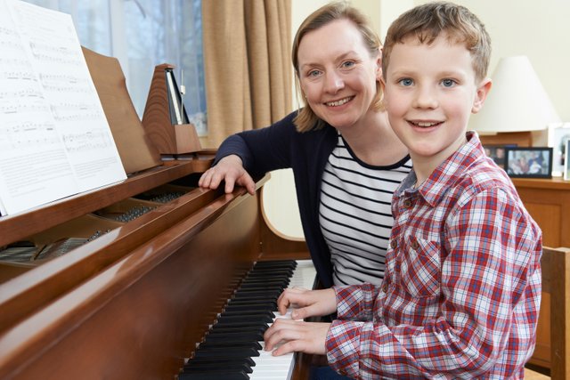 bigstock-Boy-With-Music-Teacher-Having-121393850.jpg