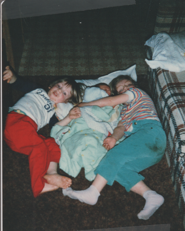 1985 apx Baby Joey Rick Katie Blanket Laying Smiling.png