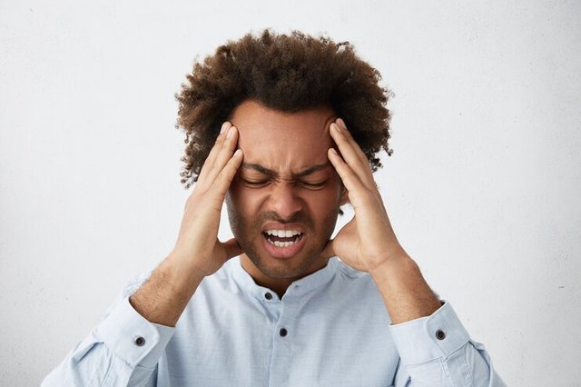 stressed-mixed-race-man-with-head-curly-hair-frowning-his-face-holding-hands-head_273609-14078.jpg