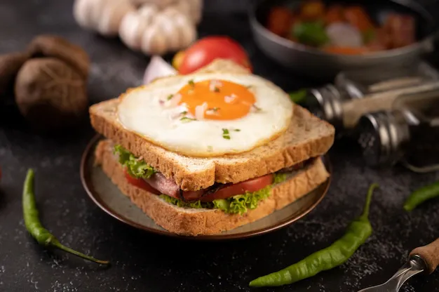 breakfast-sandwich-made-with-bread-fried-egg-ham-lettuce_1150-25679.webp