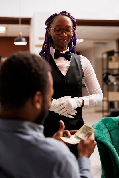 tips-gratuities-happy-african-american-waitress-wearing-uniform-receiving-tip-from-satisfied-generous-customer-hotel-bar-feeling-excited-traveler-paying-with-cash-resort-services_482257-65029.jpg