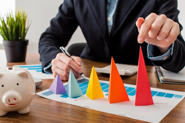 front-view-businessman-with-colorful-cones-representing-growth_23-2148780634.jpg