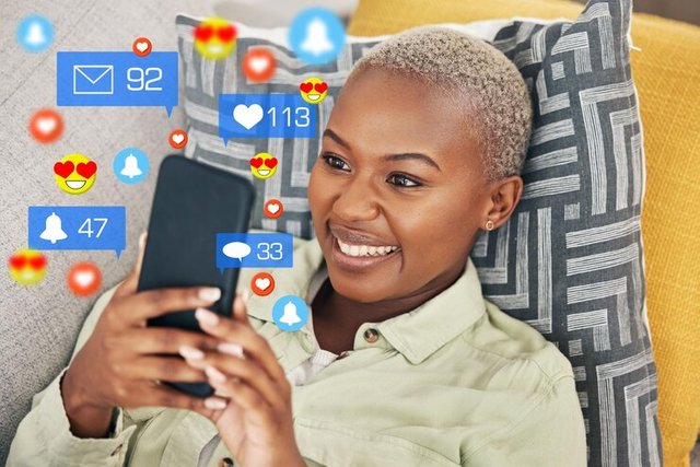 black-woman-sofa-with-phone-emoji-social-media-chat-video-online-home-happy-face-smile-internet-girl-couch-with-connectivity-smartphone-funny-viral-meme-post_590464-222508.jpg