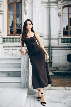 free-photo-of-a-woman-in-a-brown-dress-posing-on-steps.jpeg