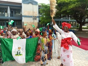 free-photo-of-women-with-flags-of-nigeria-during-parade.jpeg