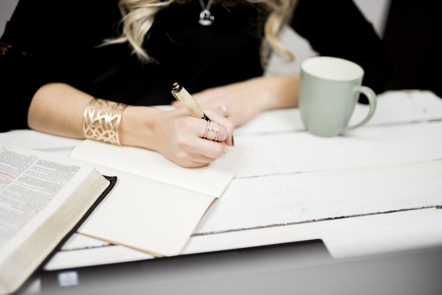 selective-closeup-shot-of-a-person-taking-notes-off-of-a-book.jpg