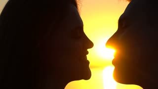 videoblocks-silhouette-of-young-romantic-couple-two-lovers-young-man-and-woman-kissing-at-ocean-sea-sunset-close-up-trust-love-travel-and-happiness-vacation-tourist-trip-concept-slow-motion_hogbkdwq9q_thumbnail-small01.jpg