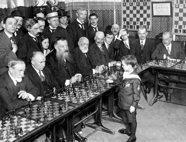 Samuel Reshevsky, age 8, defeating several chess masters at once in France, 1920.JPG