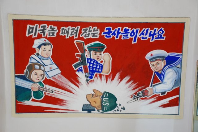 Propaganda_poster_in_a_primary_school_-_DPRK_(2604154887).jpg