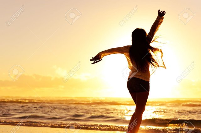 11900499-carefree-woman-dancing-in-the-sunset-on-the-beach-vacation-vitality-healthy-living-concept.jpg