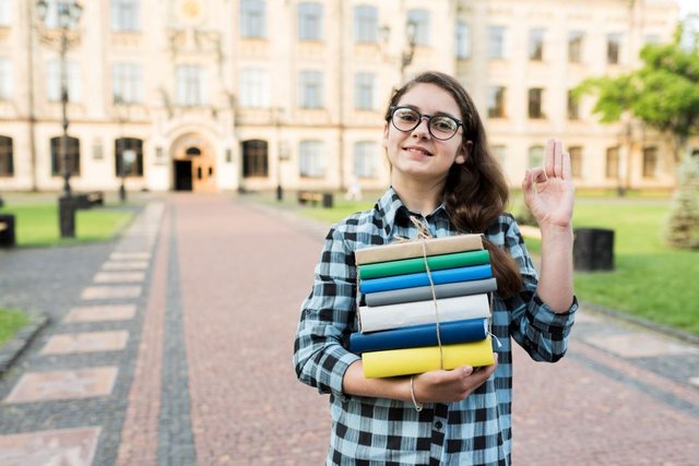 medium-shot-highschool-girl-holding-books-hands1.jpg