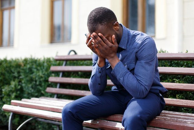 tired-african-american-man-sits-bench-outside.jpg