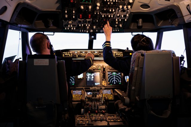 captain-and-woman-copilot-getting-ready-to-fly-airplane-and-takeoff-with-dashboard-navigation-in-cockpit-command-airline-crew-fixing-altitude-level-and-with-control-panel-buttons-flying-plane.jpg