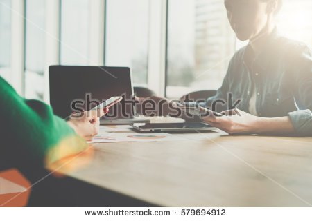 stock-photo-business-meeting-two-young-business-women-sitting-across-table-from-each-other-holding-579694912.jpg