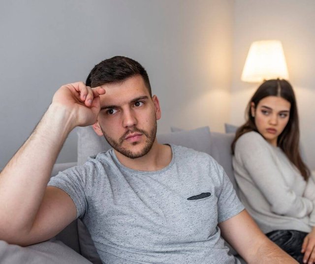 Couple-sitting-on-a-couch.-The-man-has-his-back-turned-on-the-woman.jpg