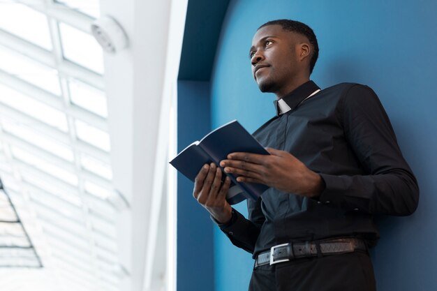 young-male-priest-holding-book_23-2149298315.jpg