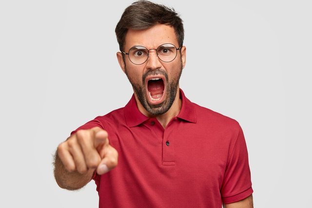 furious-depressed-male-with-dark-bristle-yells-angrily-someone-points-dressed-bright-red-tshirt-isolated-white-wall-unshaven-mad-man-expresses-rage-shouts-loudly_273609-16211.jpg