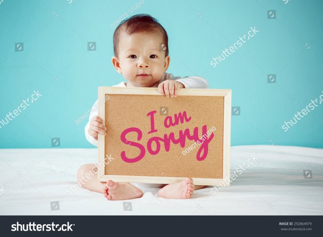 stock-photo-baby-writing-i-am-sorry-on-the-board-new-family-concept-studio-shot-292864979.jpg