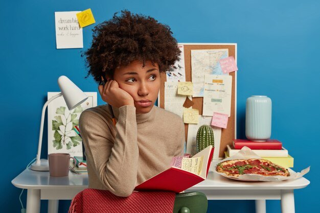 sad-thoughtful-university-student-holds-notebook-with-sticky-colorful-notes-inside_273609-33776.jpg