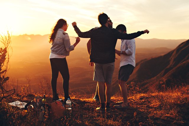 four-person-standing-at-top-of-grassy-mountain-697244.jpg