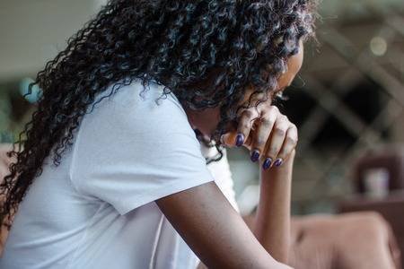 80930737-black-attractive-woman-sitting-on-the-couch-and-crying-.jpg