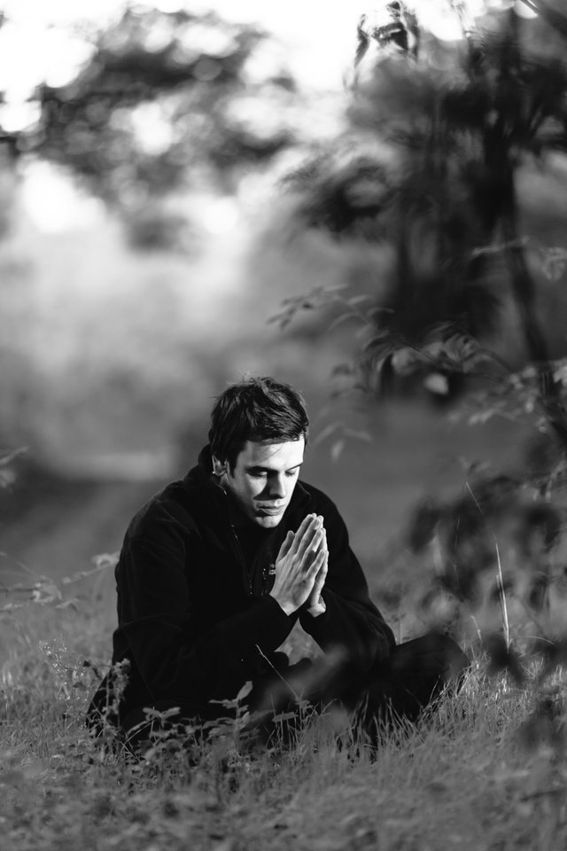grayscale-photography-of-man-sitting-on-grass-field-156151.jpg