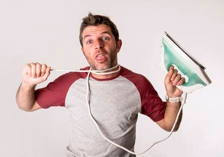 71394789-young-crazy-desperate-and-frustrated-man-doing-housework-holding-iron-and-cable-stressed-and-confuse.jpg