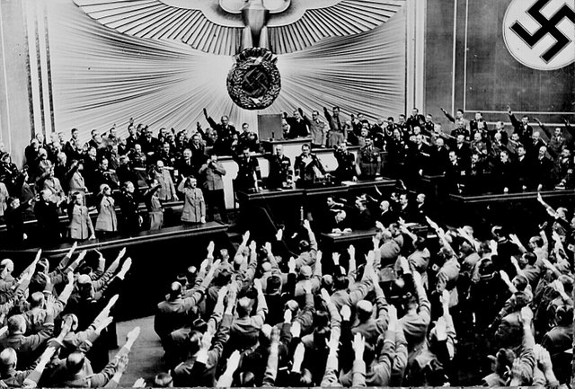 Hitler_accepts_the_ovation_of_the_Reichstag_after_announcing_an_Anschluss_with_Austria,_Berlin,_March_1938.jpg