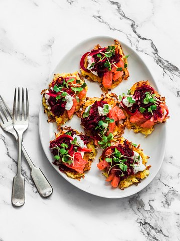 delicious-tapas-appetizers-potato-latkes-with-pickled-beetroot-salmon-yogurt-and-micro-greens.jpg