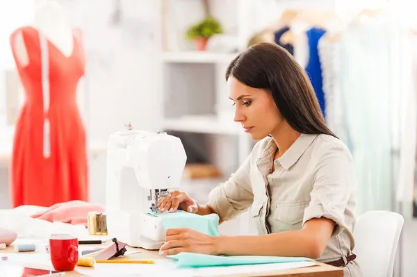 depositphotos_77471008-stock-photo-woman-sewing-while-sitting-at.jpg