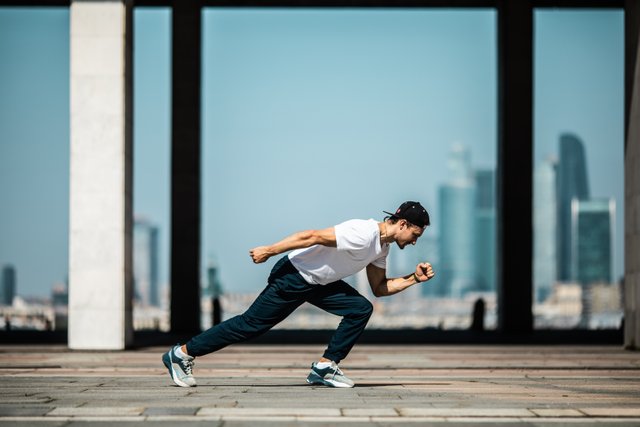 man-in-white-t-shirt-and-black-pants-in-a-running-position-4048182.jpg