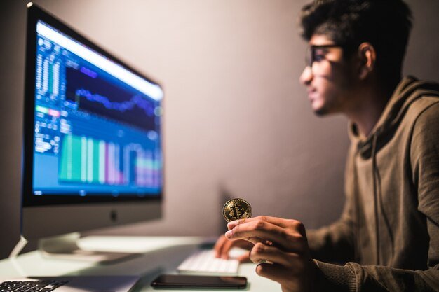 indian-bitcoin-trader-checking-stock-trading-data-analysis-concept-working-office-with-financial-graph-computer-monitors_231208-3645.jpg