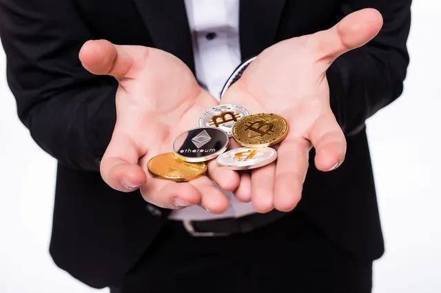 man-holds-different-crypto-coins-his-hands-white_231208-4023.webp