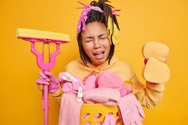 housewife-tired-cleaning-house-whole-day-holds-sponge-mop-expresses-negative-emotions-dressed-casual-domestic-clothes-isolated-yellow_273609-48837.jpg