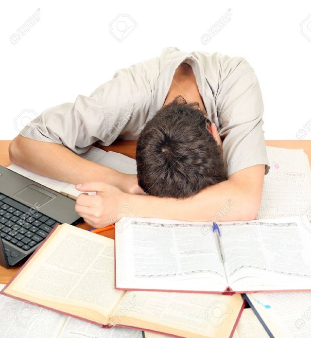 16908020-tired-student-sleeping-on-the-school-desk-isolated-on-the-white-background.jpg