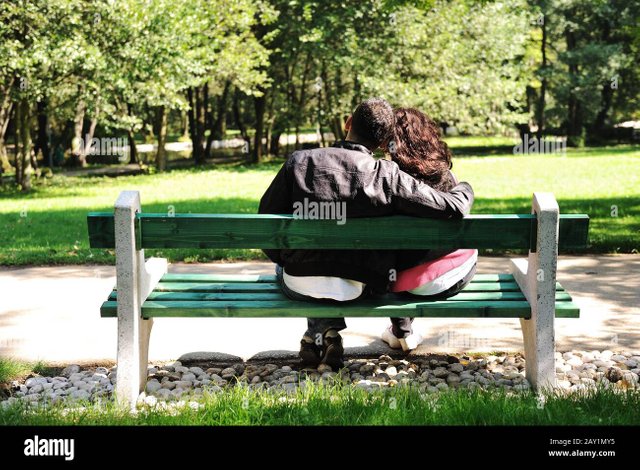 young-couple-in-love-sitting-in-nature-on-bench-lovers-in-park-2AY1MY5.jpg