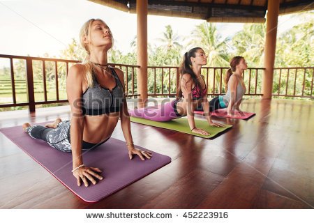 stock-photo-fitness-women-practicing-the-cobra-pose-during-yoga-class-in-a-health-center-fitness-group-doing-452223916.jpg