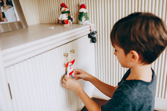 free-photo-of-a-young-boy-is-putting-a-toy-on-the-shelf.jpeg