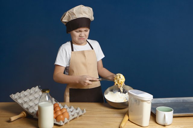 what-mess-disappointed-male-kid-trying-to-beat-eggs-with-flour-and-milk-while-making-dough-by-himself-for-the-first-time-but-having-some-problem.jpg