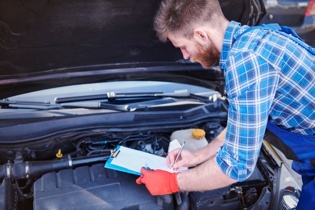 mechanic-repairing-car-workshop.jpg