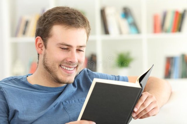 happy-guy-reading-paper-book-sitting-sofa-home-happy-man-reading-paper-book-home-102830406.jpg