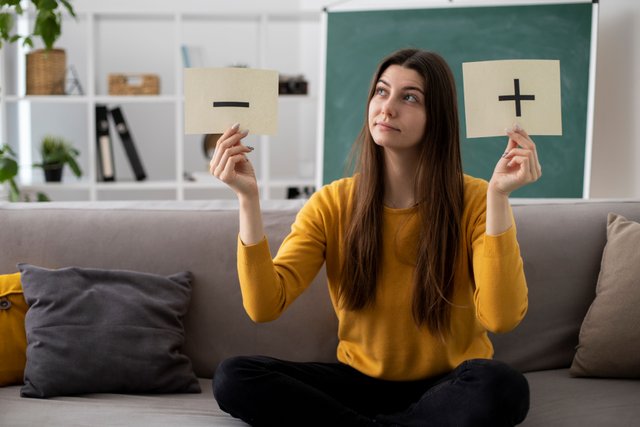 full-shot-woman-couch-with-paper.jpg