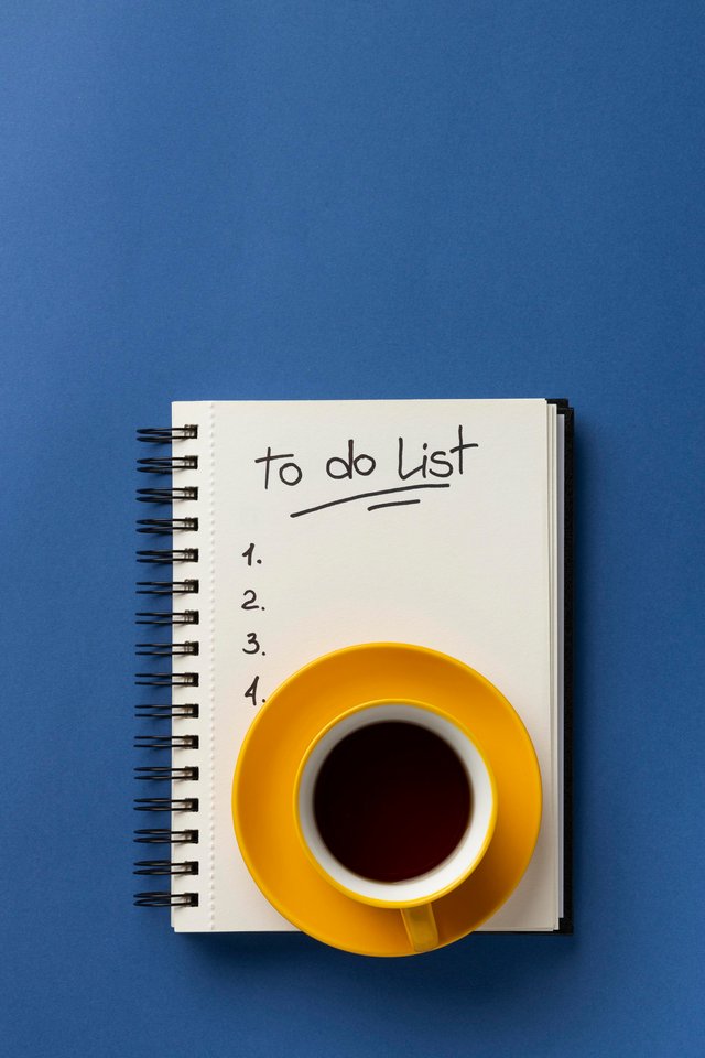 notebook-with-list-desk-with-cup-coffee-beside.jpg