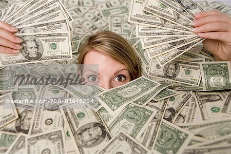 700-01646204em-woman-surrounded-by-money.jpg