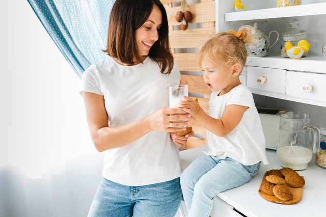 mother-offering-glass-milk-her-daughter_23-2148339836.jpg