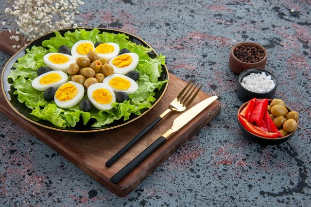 front-view-egg-salad-green-salad-olives-with-tomatoes-light-background_179666-17243.jpg