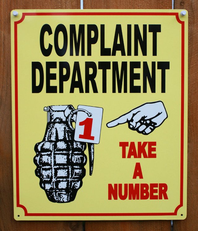 inkfrog178376730-234-complaint-department-take-a-number-tin-sign-grenade-work-office-humor-lol-e11.jpg
