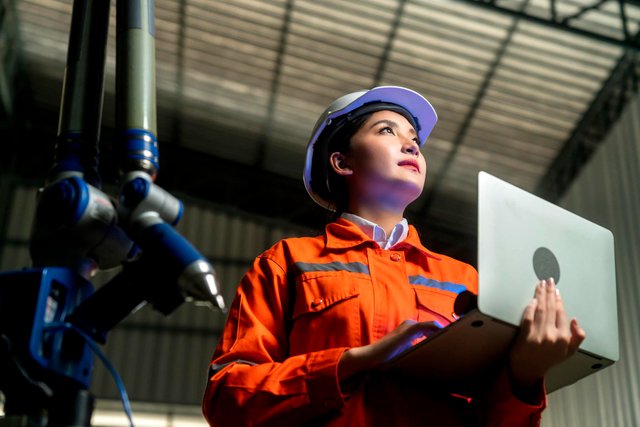 engineer-specialist-asian-female-technician-maintenance-inspect-relay-robot-arm-system-with-laptop-control-quality-operate-process-work-heavy-industry-40-manufacturing-smart-factory.jpg