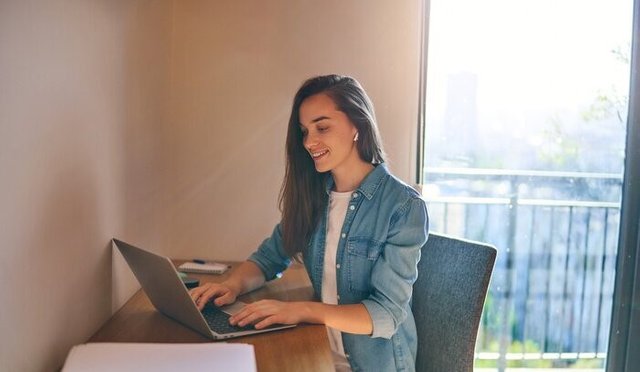 happy-young-casual-smart-modern-smiling-girl-freelancer-with-wireless-headphone-using-laptop-during-remote-working-online-at-home-700-262257154.jpg