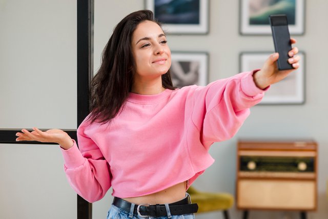 young-blogger-holding-her-smartphone-up.jpg